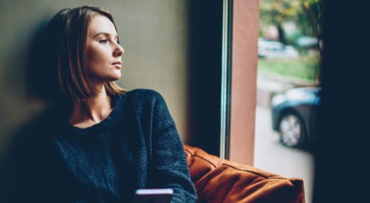 woman looking lonely out of window