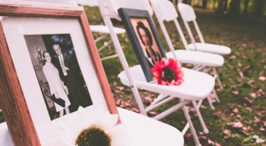 photographs and flowers on chairs as memorial