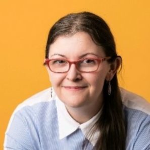 kate laverty facing camera with orange background