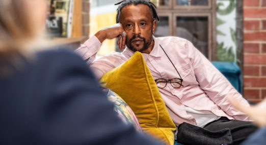 Man listening to a woman on a sofa