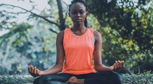 woman doing yoga in woods